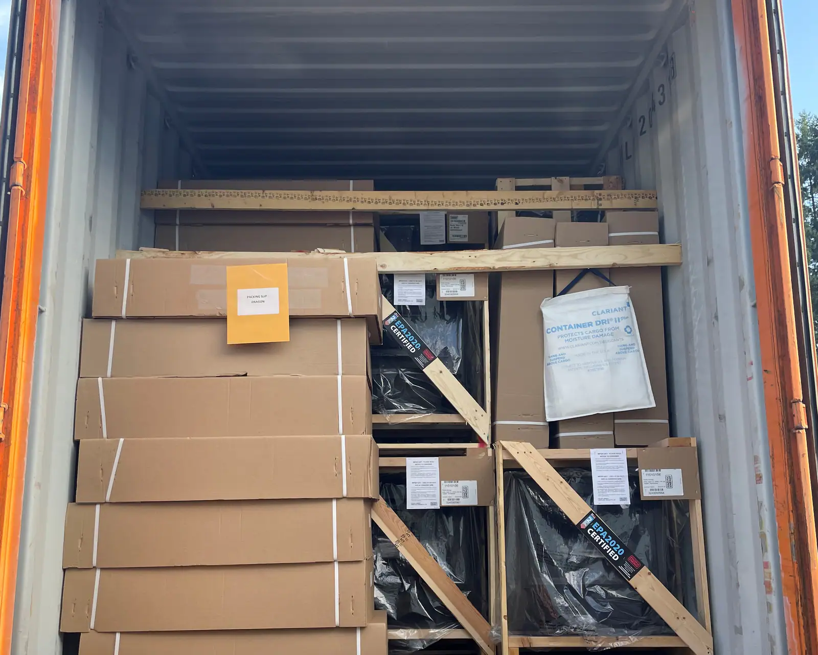 The open doors of a container on a trailer, packed with crated and boxed freight braced in timber