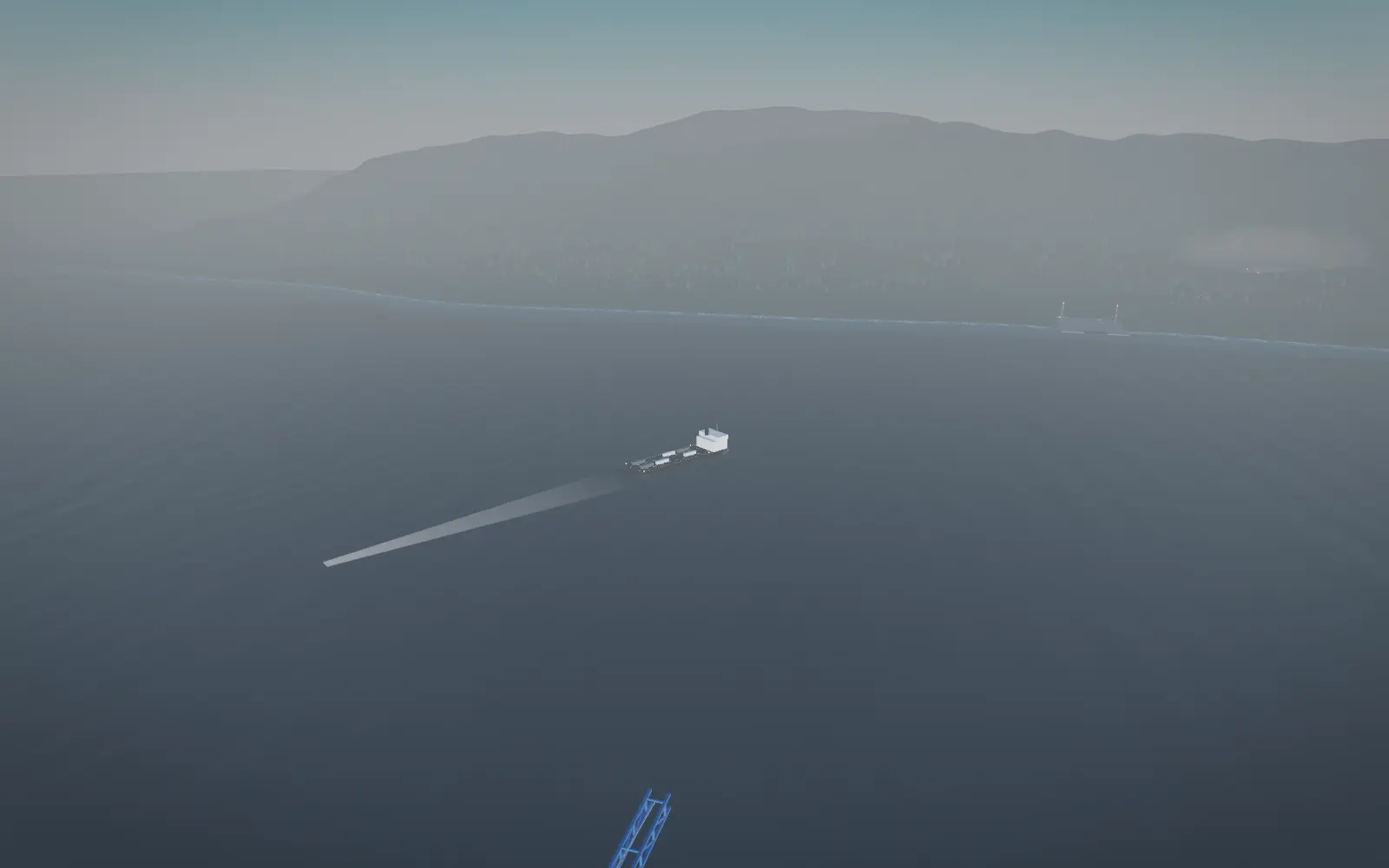 A commercial barge carrying trailers across the Strait of Georgia toward Vancouver Island